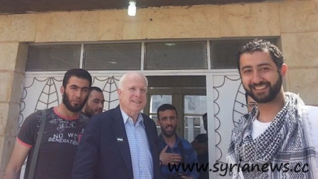 Hawkish US Senator John McCain (C) poses with infamous kidnapper in Syria, Mohamed Nour (seen with his hand on his chest and holding a camera)