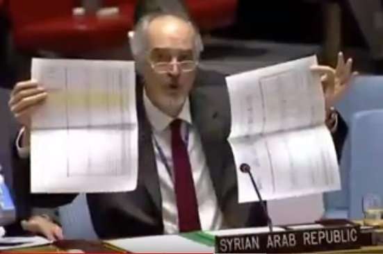 Jaafari holds documents from sarc. 182 intra-syrian convoys deployed this year