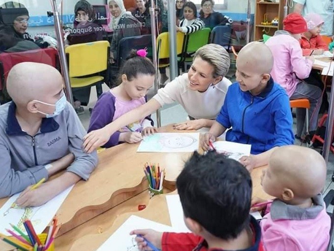 First Lady Asmaa Assad with children receiving treatment from cancer at al-Biruni University Hospital