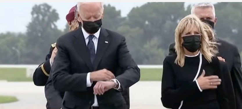 Demented Joe checks his watch at the somber occasion of Americian troops killed by terrorists coming home in caskets.  