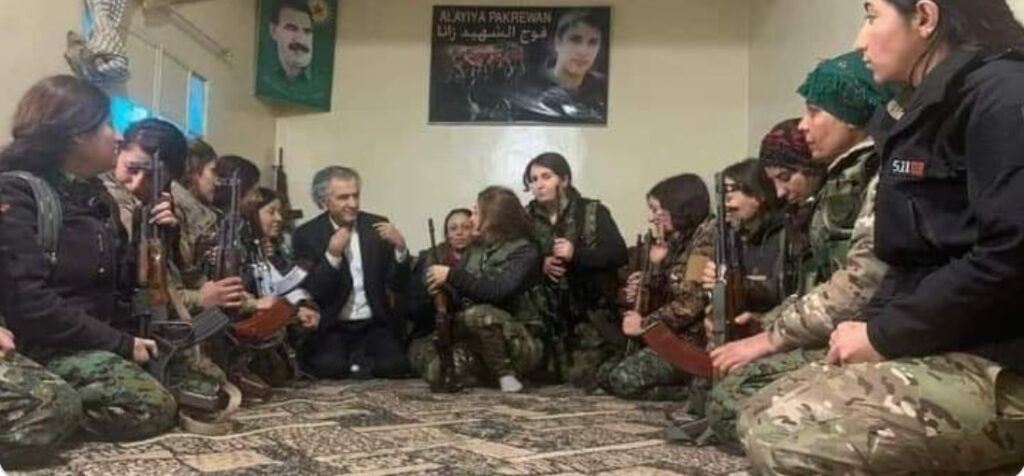 Great white hope illegally in Syria, with young, armed, female SDF terrorists.