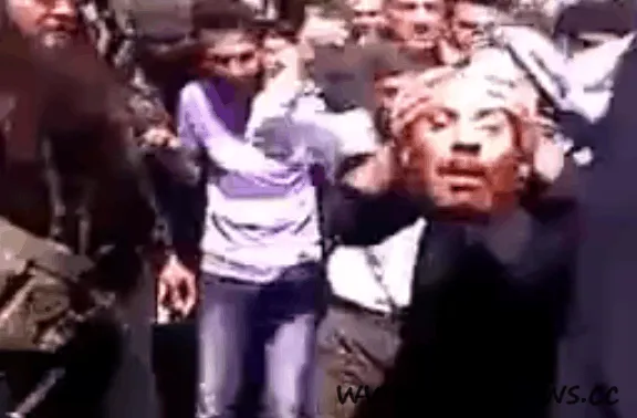 The severed head of the priest is shown to the crowd.