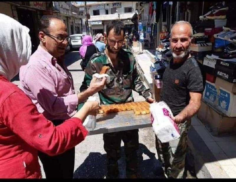 Syrians distributing sweets on the streets in Suqaylabiyah