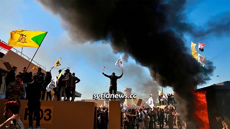 Iraqis march on the US Embassy in Baghdad protesting the massacre of 30 members of Iranian-allied militia fighting ISIS