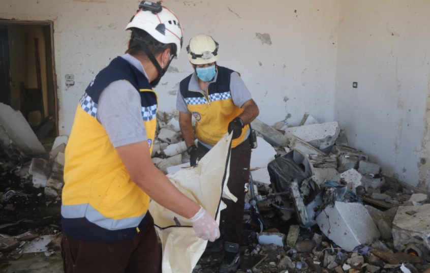 White Helmets carrying phony body bag.