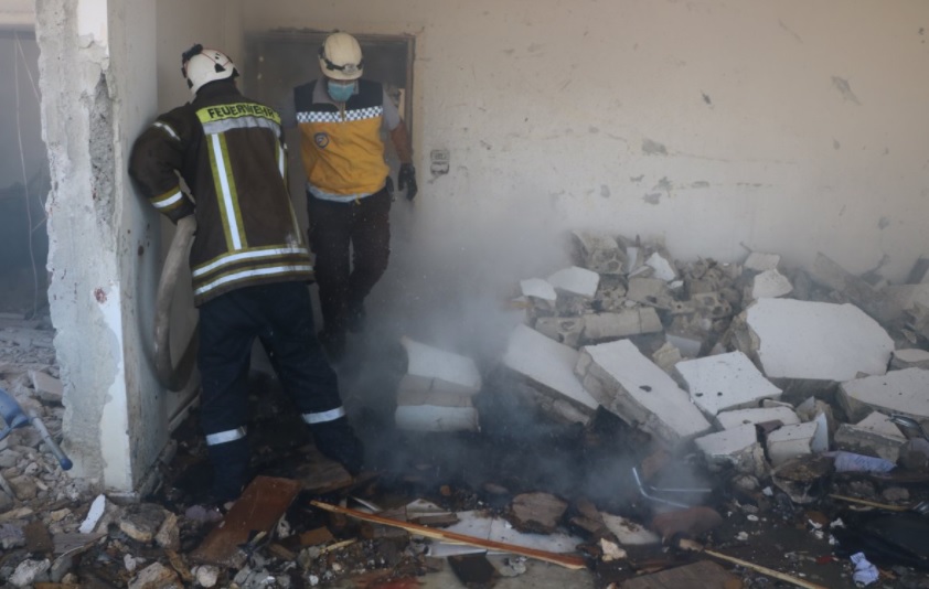 White Helmets in staged rescue scene in Sarmada.
