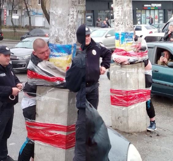 Ukraine Nazi cops torture civilians whose photos are taken by Nazi bystanders.