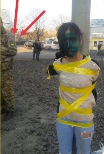 Ukraine Nazi soldier tortures girl, paints face with animal antifungal