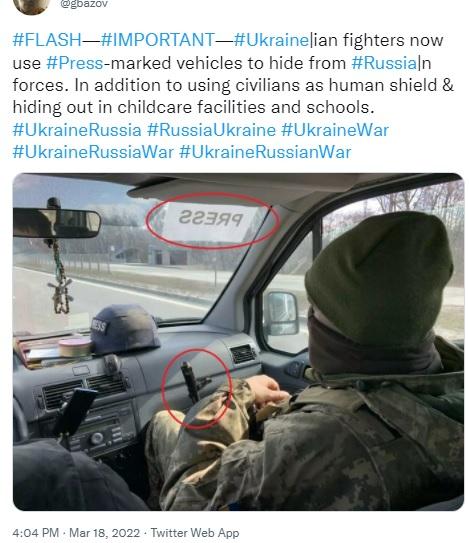 Armed Ukraine soldier in PRESS vehicle.