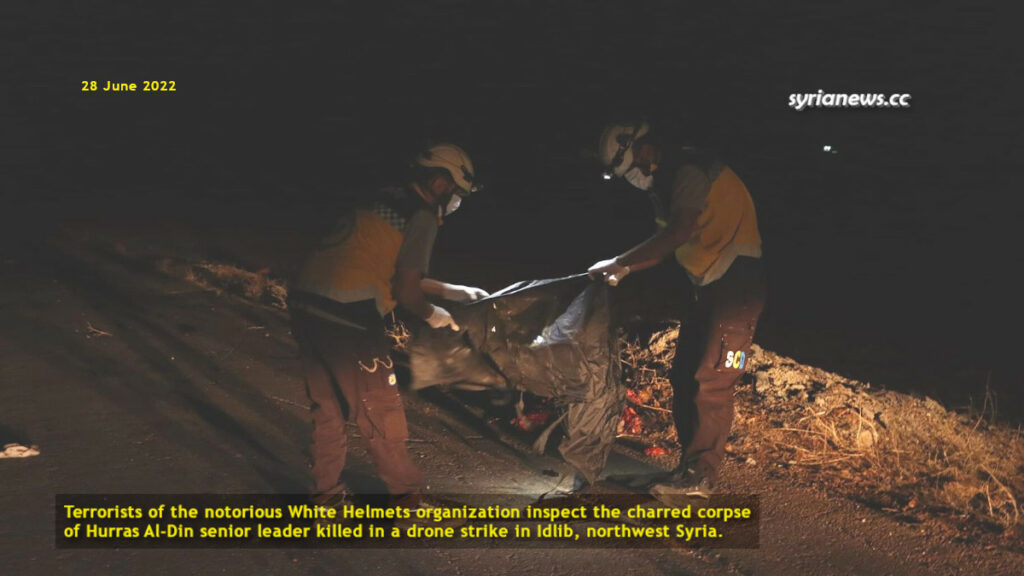 Terrorists of the notorious White Helmets org inspect the charred corpse of senior leader of Hurras al-Din killed in a drone strike in Idlib - al qaeda